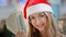 Close up portrait happy rich Caucasian woman in red Santa Christmas hat cap and eyeglass holding money dollars celebrate
