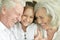 Close up portrait of happy senior couple with granddaughter at home