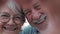 Close up portrait happy sincere middle aged elderly retired family couple making heart gesture with fingers, showing love or