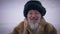 Close-up portrait happy smiling bearded old man in hat looking at camera. Cheerful senior indigenous retiree posing at