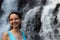 Close up portrait of happy woman at waterfall. Smiling Caucasian woman. Travel lifestyle. Jembong waterfall, Bali, Indonesia