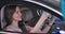 Close-up portrait of happy young Caucasian woman sitting in car with family and smiling. Beautiful mother and wife