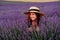 Close up portrait of a happy young woman in a dress on blooming fragrant lavender fields with endless rows. . Bushes of