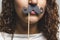 Close up portrait head shot of Young girl wearing fake mustaches - Girl holding funny mustache on stick