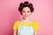 Close-up portrait of her she nice attractive cheerful brown-haired housewife wearing rollers isolated over pink color