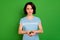 Close-up portrait of her she nice attractive lovely candid peaceful kind girl wearing blue t-shirt holding in hands