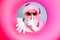 Close-up portrait of his he nice attractive mysterious bearded Santa in inflatable circle showing shh symbol sale