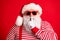 Close-up portrait of his he nice handsome mysterious white-haired Santa wearing sunglasses showing shh sign silence