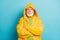 Close-up portrait of his he nice serious grey-haired man fisherman wearing yellow overcoat folded arms bad weather news