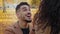 Close-up portrait hispanic young guy kneeling in front of girlfriend outdoors man making marriage proposal to beautiful