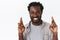 Close-up portrait hopeful, optimistic and cheerful african-american bearded man having faith in dreams come true, cross