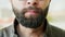 Close-up portrait of hungry bearded man eating ice cream