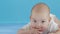 Close-up portrait a infant girl. The face of a Caucasian little girl lying on the bed. baby 6 mounth looking in camera.