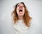 Close-up portrait of insane woman in straitjacket on white background.