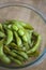 Close up portrait of Japanese food edamame nibbles, boiled green soybeans