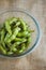 Close up portrait of Japanese food edamame nibbles, boiled green soybeans