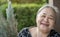 Close up portrait of kind Asian senior woman smiling at camera at home