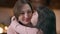 Close-up portrait laughing happy mother hugging little daughter indoors. Caucasian beautiful slim woman enjoying leisure
