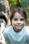 Close-up portrait of little beautiful biracial asian girl on blurred rustic background with lovely bokeh