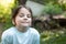 Close-up portrait of little beautiful biracial girl on blurred country background with lovely bokeh