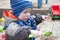 Close-up portrait - A little boy of three years old on a cool spring sunny day playing in the sandbox of a kindergarten