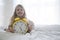 Close-up portrait of little girl with huge alarm clock in her hands