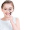 Close-up portrait of little girl looking through a magnifying