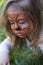 Close-up portrait of a little girl with tiger aqua makeup. conceptual portrait of a tiger