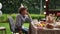 Close up portrait of a lonely sad teenager sitting at the birthday table. A curly-haired boy in a birthday hat spends