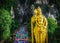 Close up portrait of Lord Murugan Statue in foothills of limestone outcrop, Batu Caves Gombak