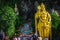 Close up portrait of Lord Murugan Statue in foothills of limestone outcrop, Batu Caves Gombak