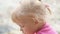 Close up portrait of lovely baby girl with cute hairs thinking above the camera