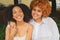 Close up portrait lovely beautiful happy lesbian African American couple hugging around city street landscape at summer