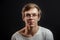 Close up portrait of male tenager in glasses isolated on the black background