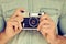 Close up portrait of man\'s hands holding vintage camera