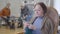 Close-up portrait of mature Caucasian woman examining knitting. Old female retiree practicing hobby in nursing home.