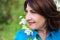 Close up portrait of middle aged woman smelling cherry tree bran