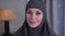 Close-up portrait of modern-looking woman with grey eyes in hijab. Young confident lady looking at camera and smiling
