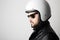 Close up portrait of motorcyclist wearing white helmet and leather jacket. Space for your text