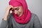 Close-up portrait of a muslim woman wearing a head scarf and smiling looking aside. Isolated.