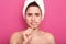 Close up portrait of naked emotional woman doing hygiene procedures with dissatisfaction, holding wooden toothbrush in her cavity