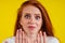 Close-up portrait of nervous unhappy young redhaired ginger woman looking at a broken fingernail and crying .nude