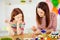 Close-up portrait of nice attractive lovely foxy ginger cheerful cheery girls small little daughter creating handicraft
