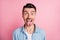 Close-up portrait of nice cheerful crazy humorous guy showing tongue out isolated over pink pastel color background