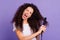 Close-up portrait of nice cute lovely attractive crazy wavy-haired lady using new electric product hot temperature care