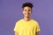 Close-up portrait of nice, friendly-looking hispanic male student in yellow t-shirt, grinning delighted, look upbeat