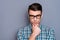 Close-up portrait of nice well-groomed handsome attractive minded guy wearing checked shirt touching chin thinking