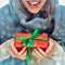 Close up portrait part of face with red christmas box