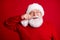 Close up portrait of positive cheerful old retire pensioner man in santa claus headwear fix mustache enjoy miracle