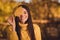 Close up portrait of positive cheerful woman environment lover enjoy rest relax autumn nature park close cover eye face